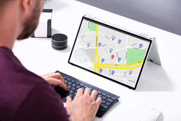 Man Browsing GPS Map On Laptop