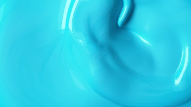 Super slow motion of mixing blue paint. Abstract background. Filmed on high speed cinema camera, 1000 fps.