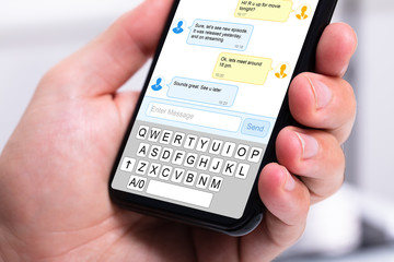 Person s hand holding mobile phone