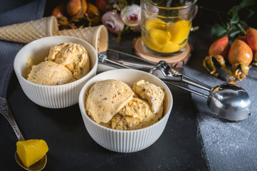 Homemade ice cream with mango on rustic background