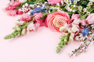 Bouquet of spring flowers on pink background.