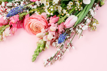 Bouquet of spring flowers on pink background.