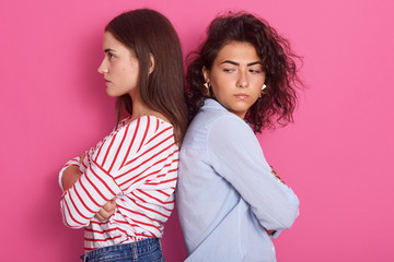 Profile portrait of beautiful girls with dark hair frowning her face in displeasure, wearing casual...