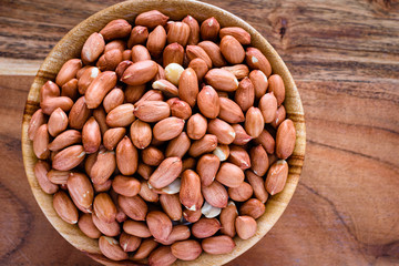 closeup of peanuts in a wooden bowl