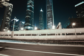 Empty road surface with city landmark buildings of night