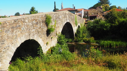 puente romano  de cuatro arcos sobre el rio furelos, galicia