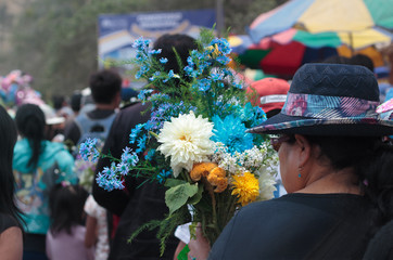  lady carrying flowers to the cemetery