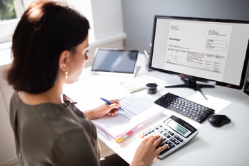 Accountant calculating tax at desk
