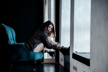 Fototapeta premium Sexy young woman at dark interior. Women's psychology and desires 