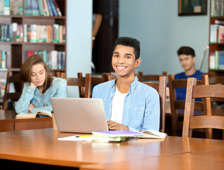 Group of students studying at table in library