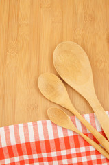 Wooden spoons on red checked tablecloth