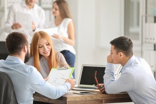 Young marketing expert with team at business meeting