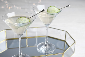 Tray with glasses of cucumber martini on grey table, space for text