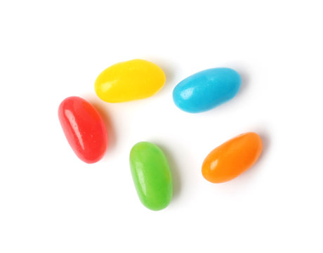 Tasty bright jelly beans isolated on white, top view