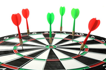 Dart board with color arrows hitting target, closeup