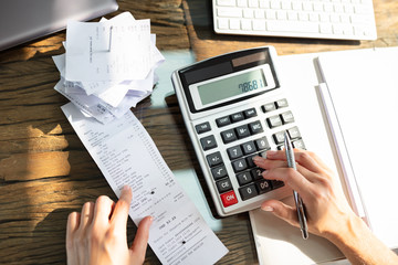 Businesswoman Checking Bill Over Desk