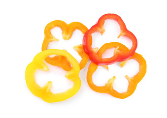 Rings of ripe bell peppers on white background, top view