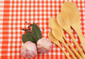 Cooking concept with spoons and food ingredients on tablecloth