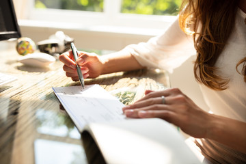 Businesswoman Signing Cheque