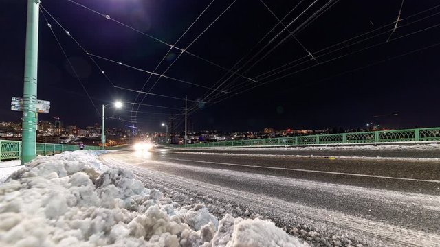Snowy Urban Street Long Exposure Time Lapse of Cars Driving at Night