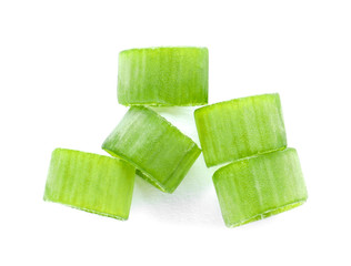 Cut fresh green onion on white background, top view
