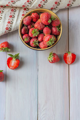 Ripe red strawberries on wooden background. Flat lay, top view, copy space