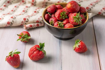 Ripe red strawberries on wooden background