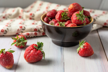 Ripe red strawberries on wooden background