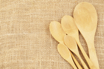 Wooden spoons on burlap background, recipe and cooking  concept