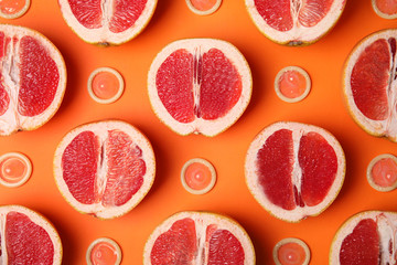 Flat lay composition with condoms and grapefruits on orange background. Erotic concept