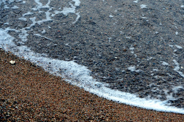 Sea water and beach sand close-up. Natural background