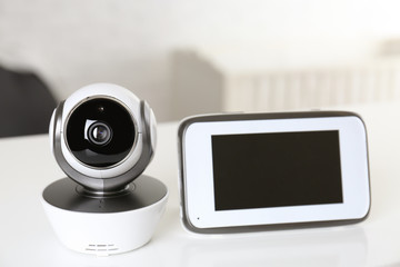 Baby monitor with camera on table in room. Video nanny