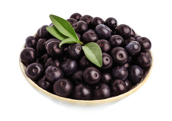 Ceramic plate with fresh acai berries on white background