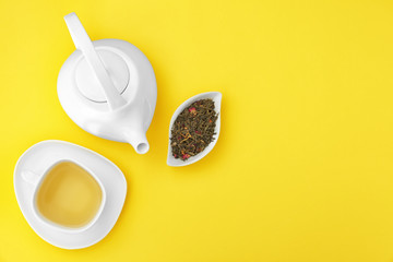 Composition with tea on yellow background, flat lay. Space for text