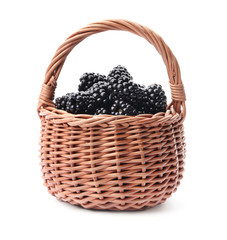 Fototapeta na wymiar Wicker basket of tasty blackberries on white background