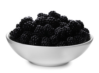 Bowl of tasty ripe blackberries on white background
