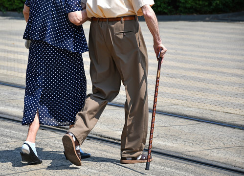 Old couple walk on the city street