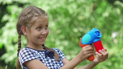 Girl playing with soap bubbles outdoor. Slow motion.