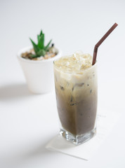Glass of iced dark green tea with milk