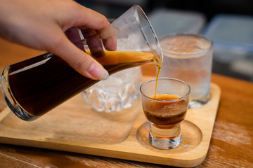 Hot dripped coffee served with a glass of ice