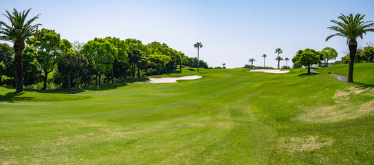 Golf Course with beautiful green field. Golf course with a rich green turf beautiful scenery. - obrazy, fototapety, plakaty