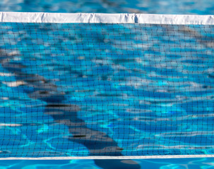 Fototapeta na wymiar Grid over the pool water