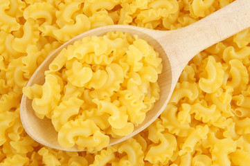Macaroni background with wooden spoon