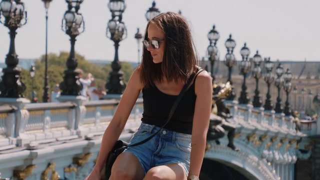Young French woman at Pont Alexandre III Bridge in Paris