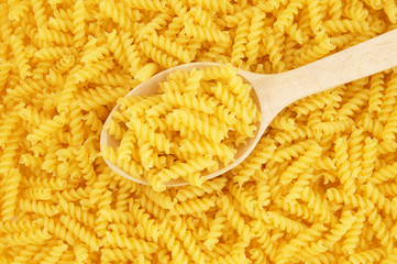 Pasta background with wooden spoon