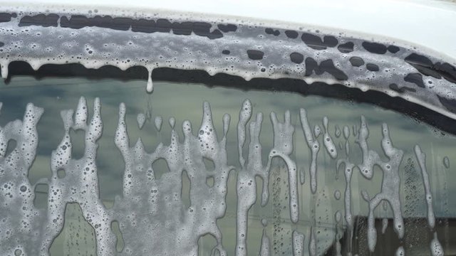Close up of water Side mirror with foam in  CarWash and Self wash Service