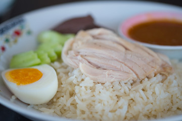 Rice steamed with chicken soup (hainanese chicken rice) served with egg