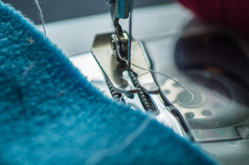  Sewing machine at work, scribble fabric on the background of a meter, scissors and threads