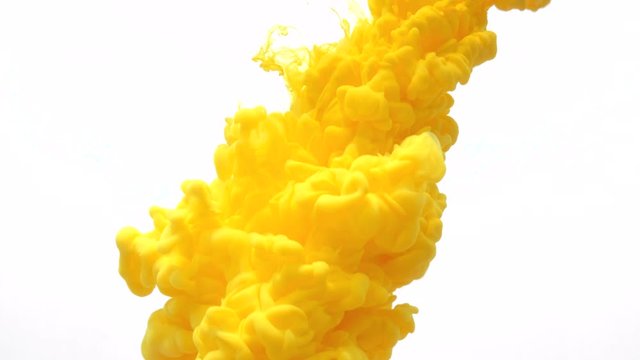 yellow ink in water. Creative slow motion. On a white background.