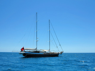 Fototapeta na wymiar Sailing ship luxury brown wooden yacht in blue sea